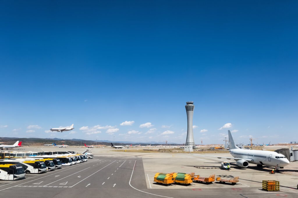 airport scene of traffic control tower and tarmac against a blue sky, yunnan, China
