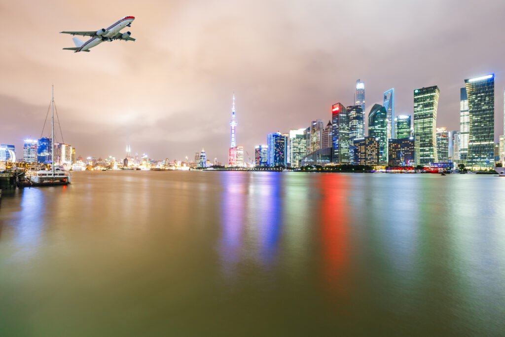 shanghai skyline with plane flying above