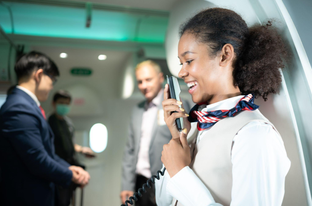 cabin crew female speaking into a phone
