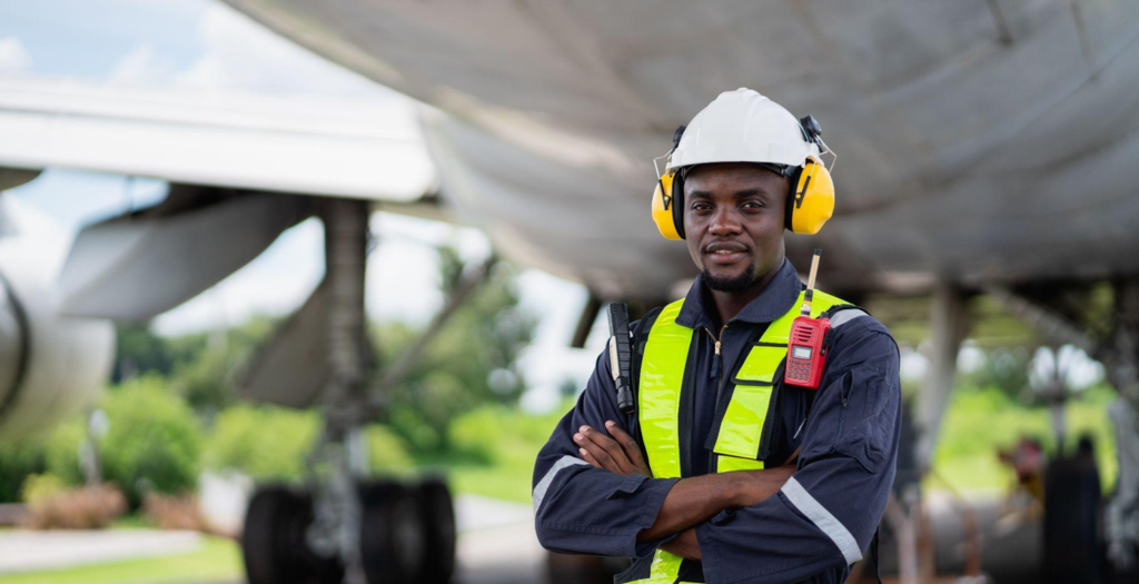 dark skinned ground gew outside an aeroplane