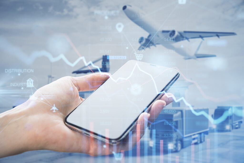 Mobile phone upheld over an airport background and overlayed on digital graph indicating digitalization of airline operations