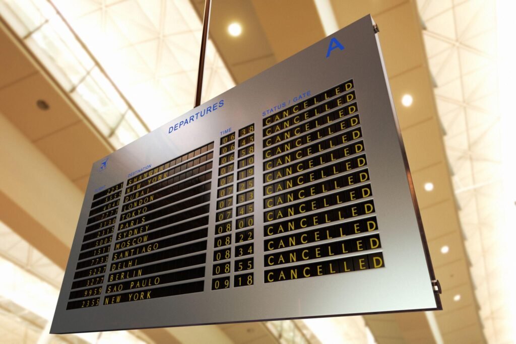 plane screen at airport, filled with cancellations. Aviation HR Talent Strategy Post Conflict