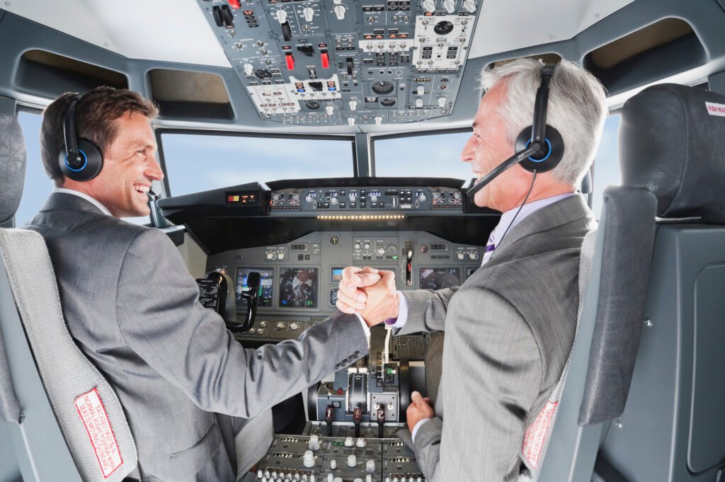 Germany, Bavaria, Munich, Businessmen piloting aeroplane from airplane cockpit