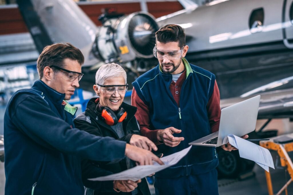 plane engineers discussing in front of an airplane.