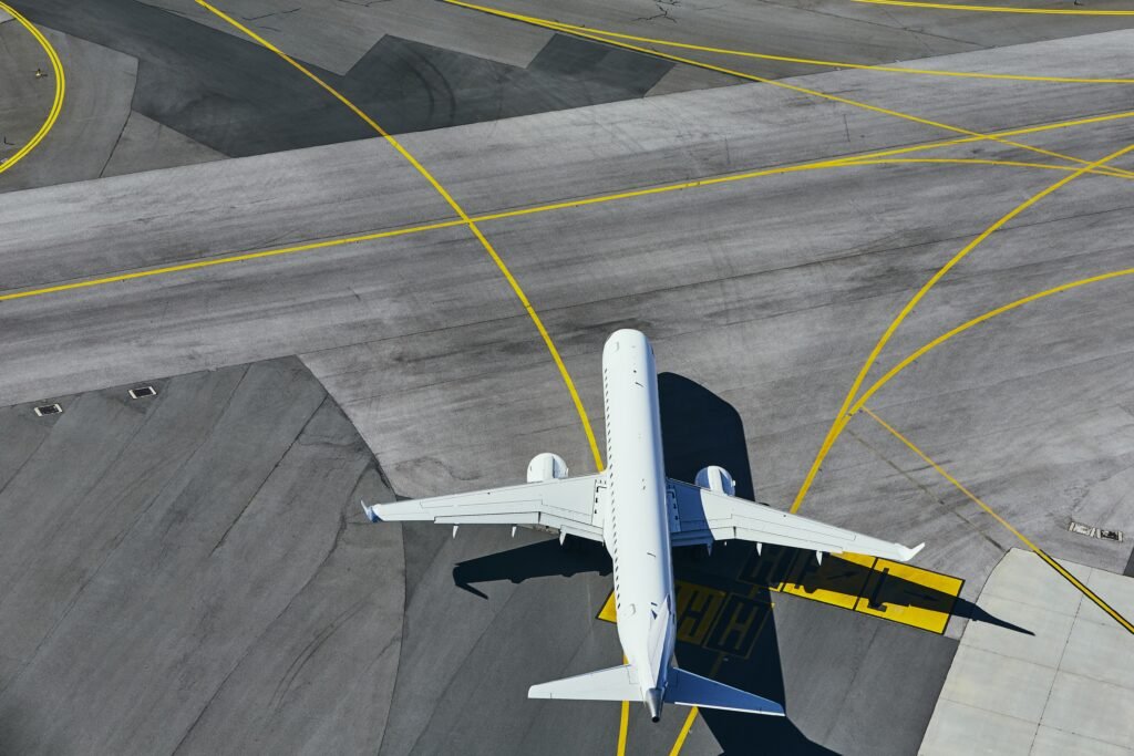 Aerial view of the airport. Airplane taxiing to runway. Aviation Growth.