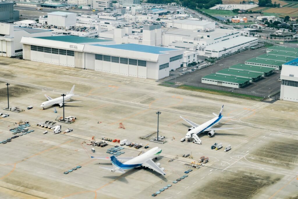 Airport apron with multiple commercial aircraft parked for ground operations. MRO Recruitment.