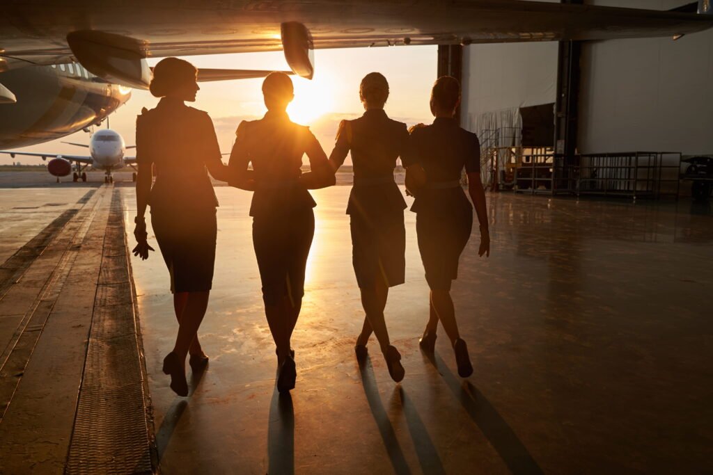 team-of-women-in-uniforms-at-airport-at-sunrise. Women in Aviation Recruitment